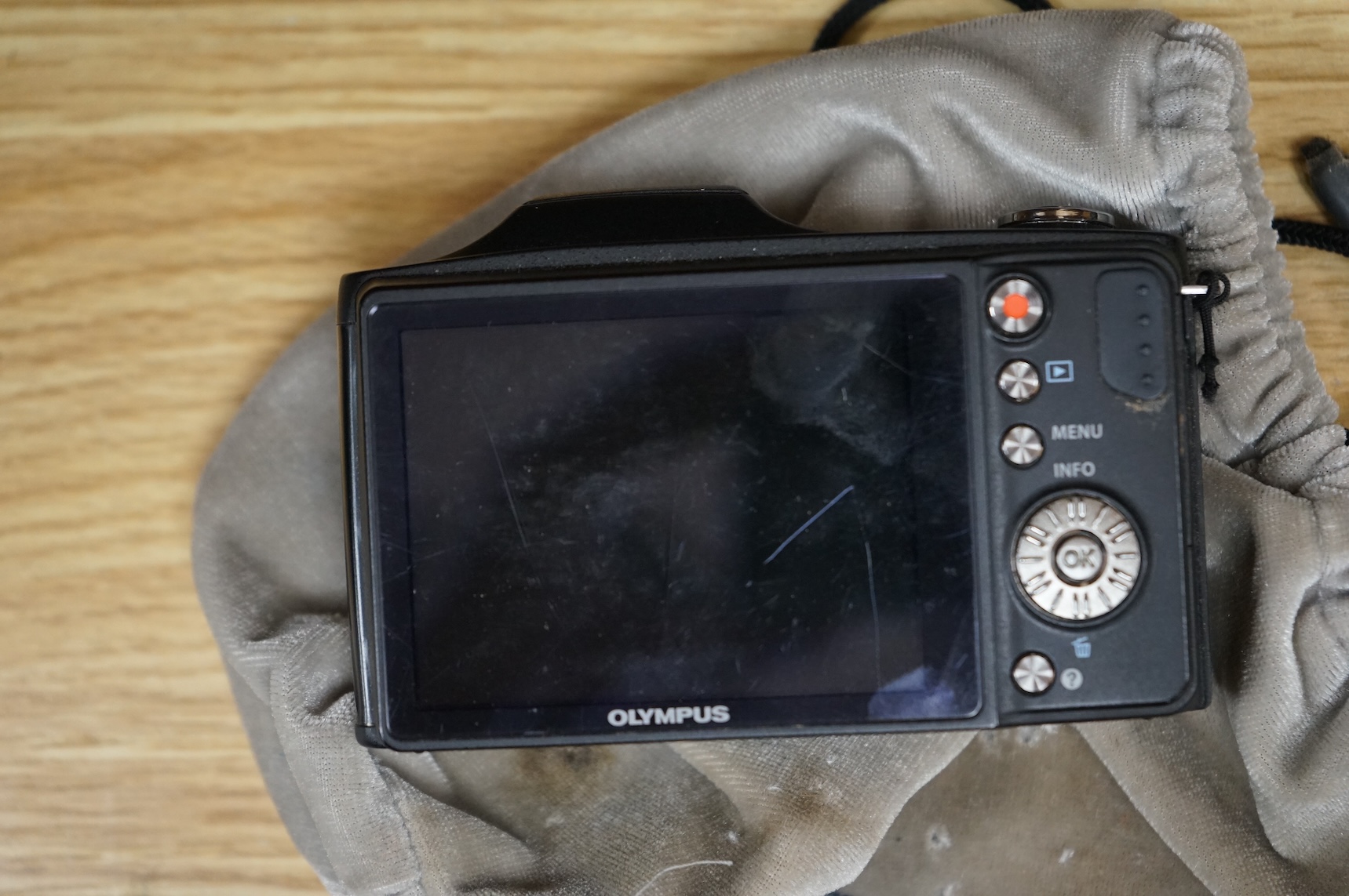 A cased Olympus 35SP camera, together with two more recent digital cameras